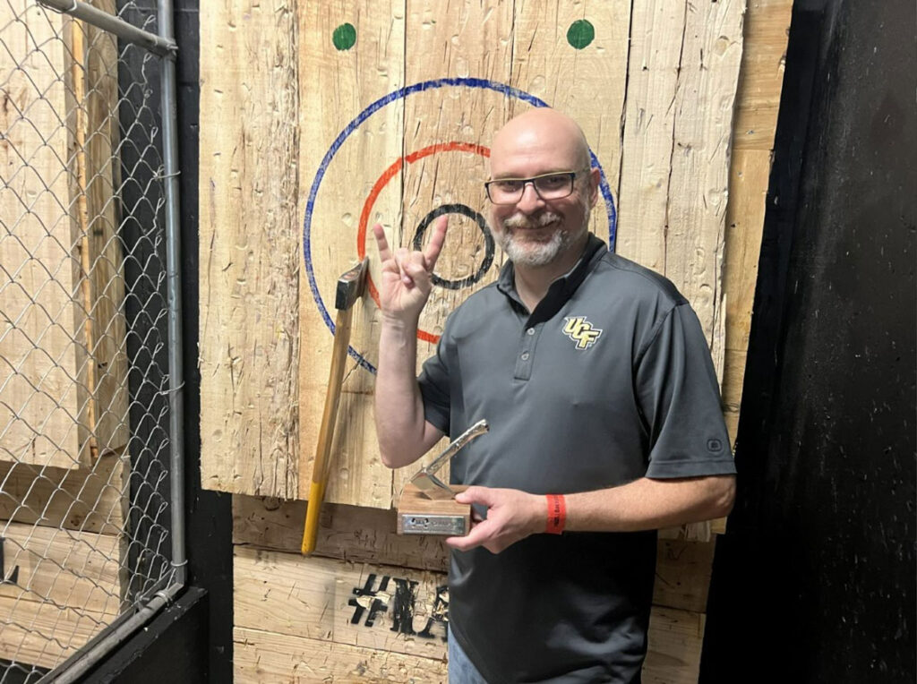 Dan Ward wins first place at the company’s axe-throwing team-building event